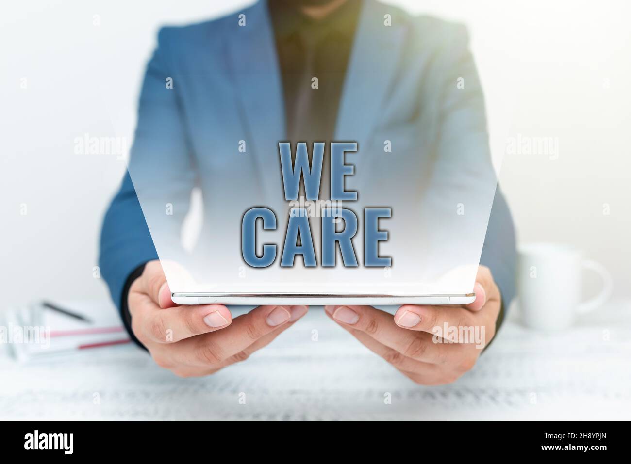 Hand writing sign We Care. Concept meaning Cherishing someones life Giving care and providing their needs Presenting Communication Technology Stock Photo