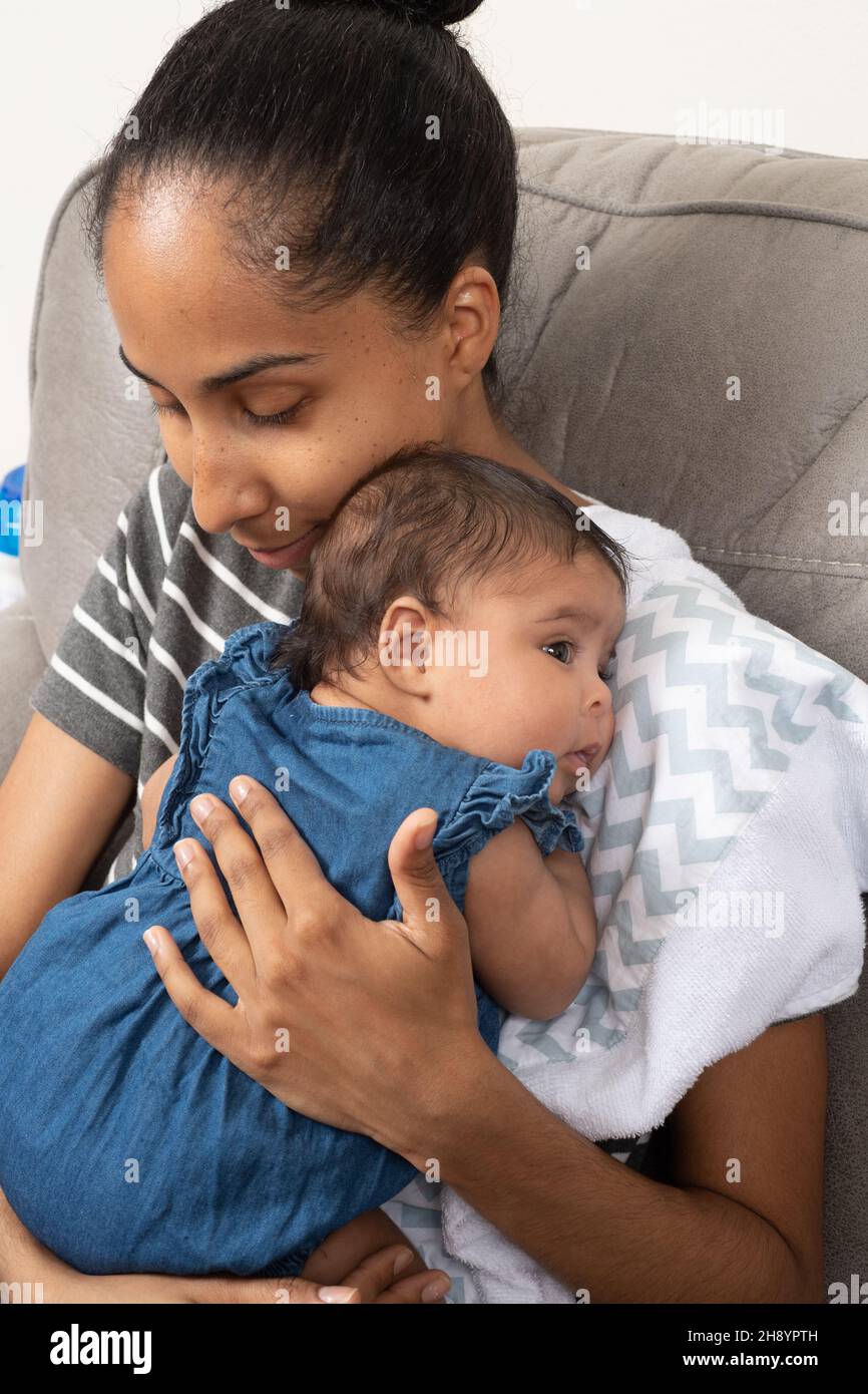 2 month old baby girl held by mother, soothed Stock Photo