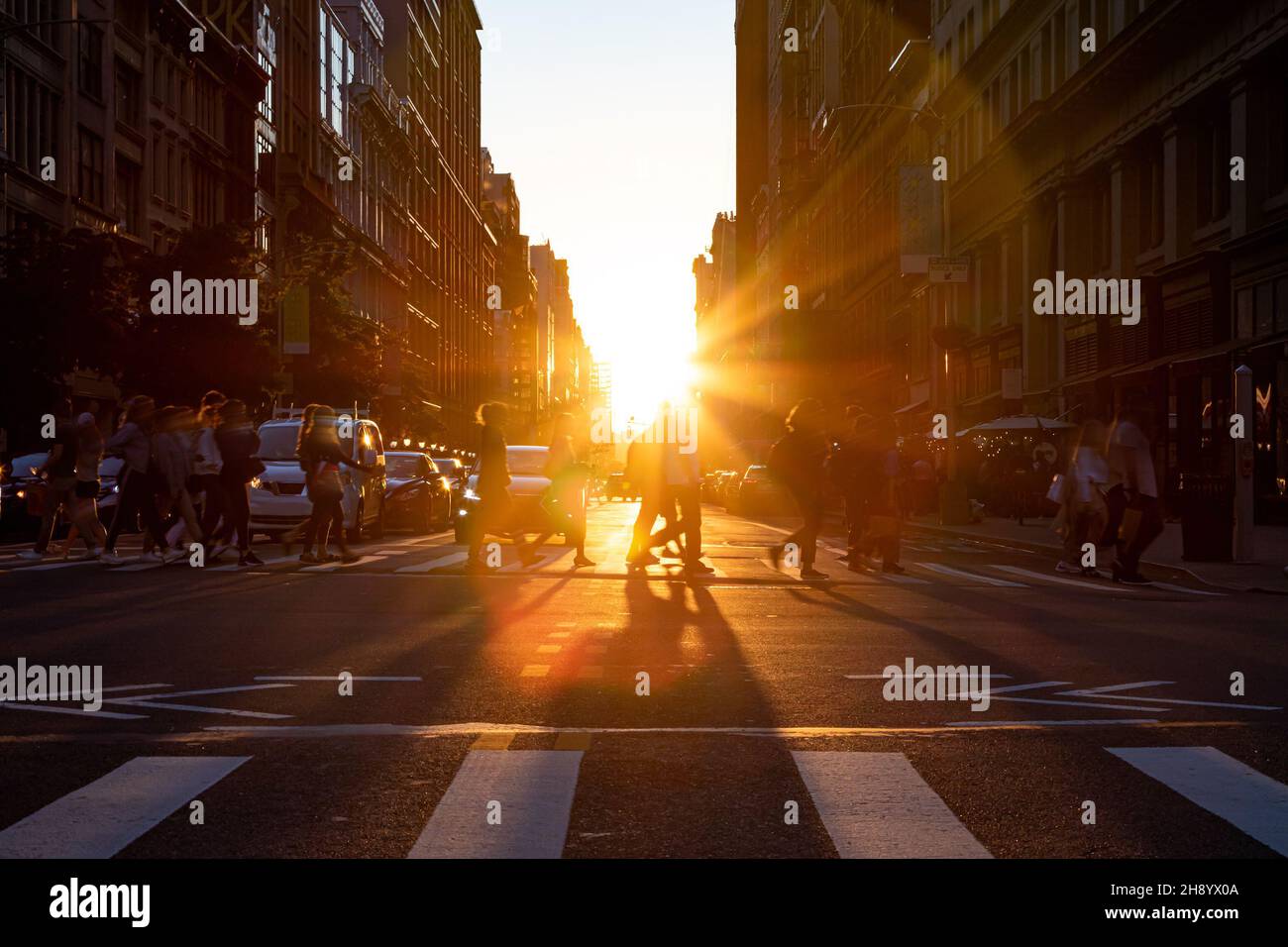 Crowds of people walking across the busy intersection on 5th Avenue in ...