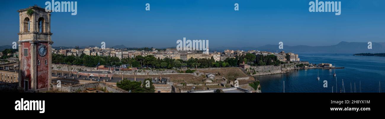 panoramic view of Old Town Corfu and the harbor framed with the Venetian clock tower from the Old Fortress on the left Stock Photo