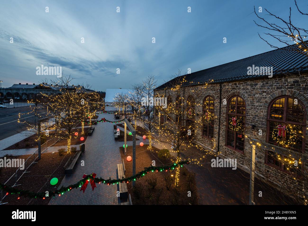 Christkindlmarkt ready to open at dusk in beautiful lights surrounded by the industrial and historic center of Bethlehem Stock Photo