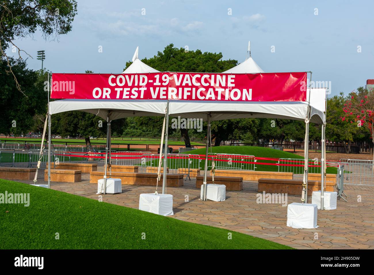 Covid-19 Vaccine or Test Verification sign on banner at the outdoor entrance to public event on stadium Stock Photo