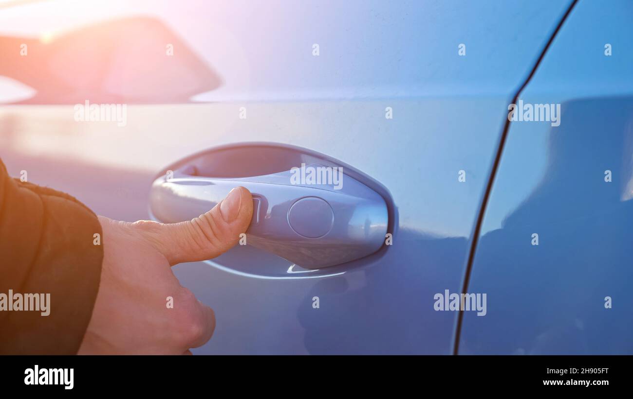 Driver uses keyless access to open and close automobile Stock Photo