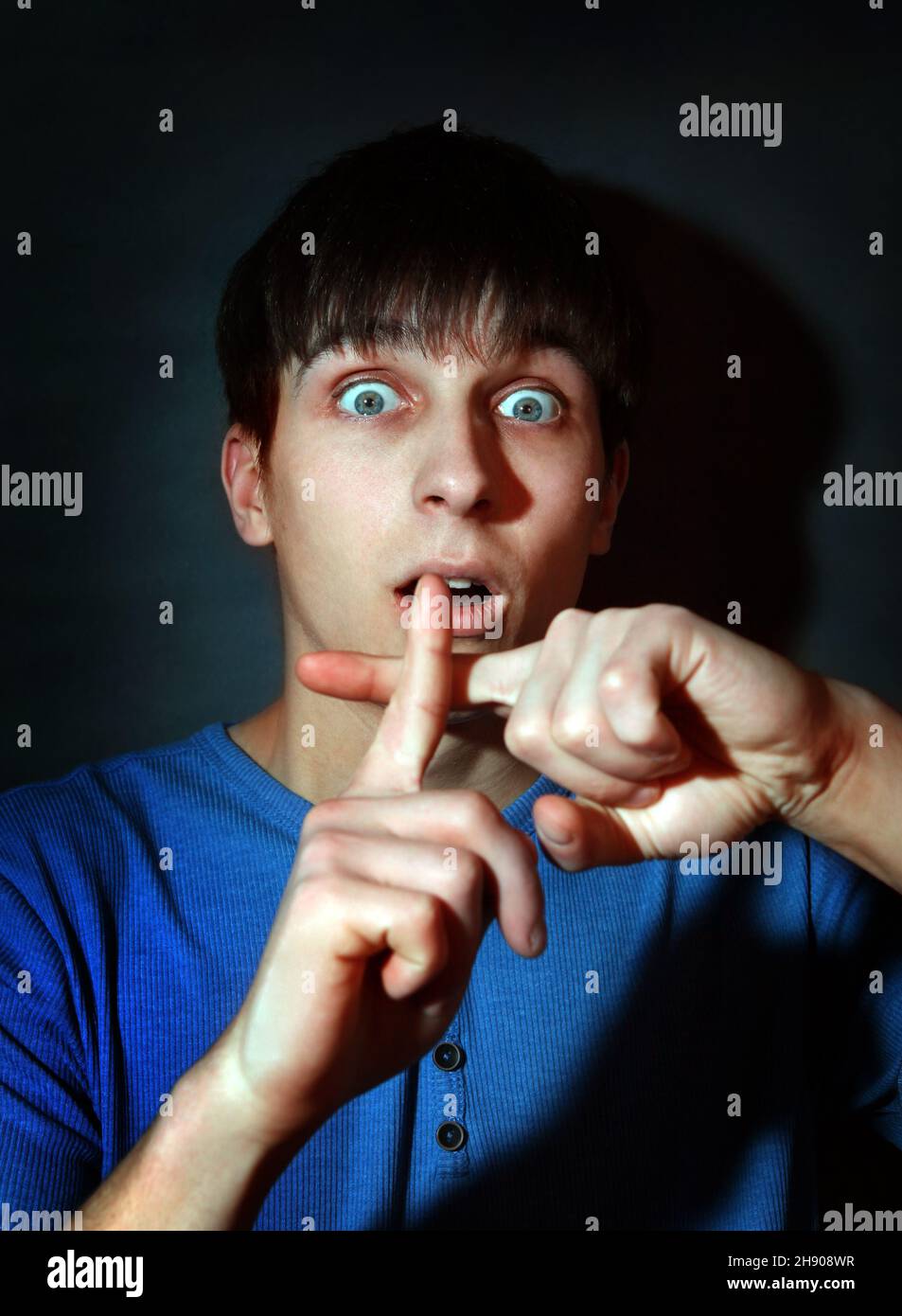 Scared Teenager in the Dark Room with Crossed Fingers Stock Photo Alamy