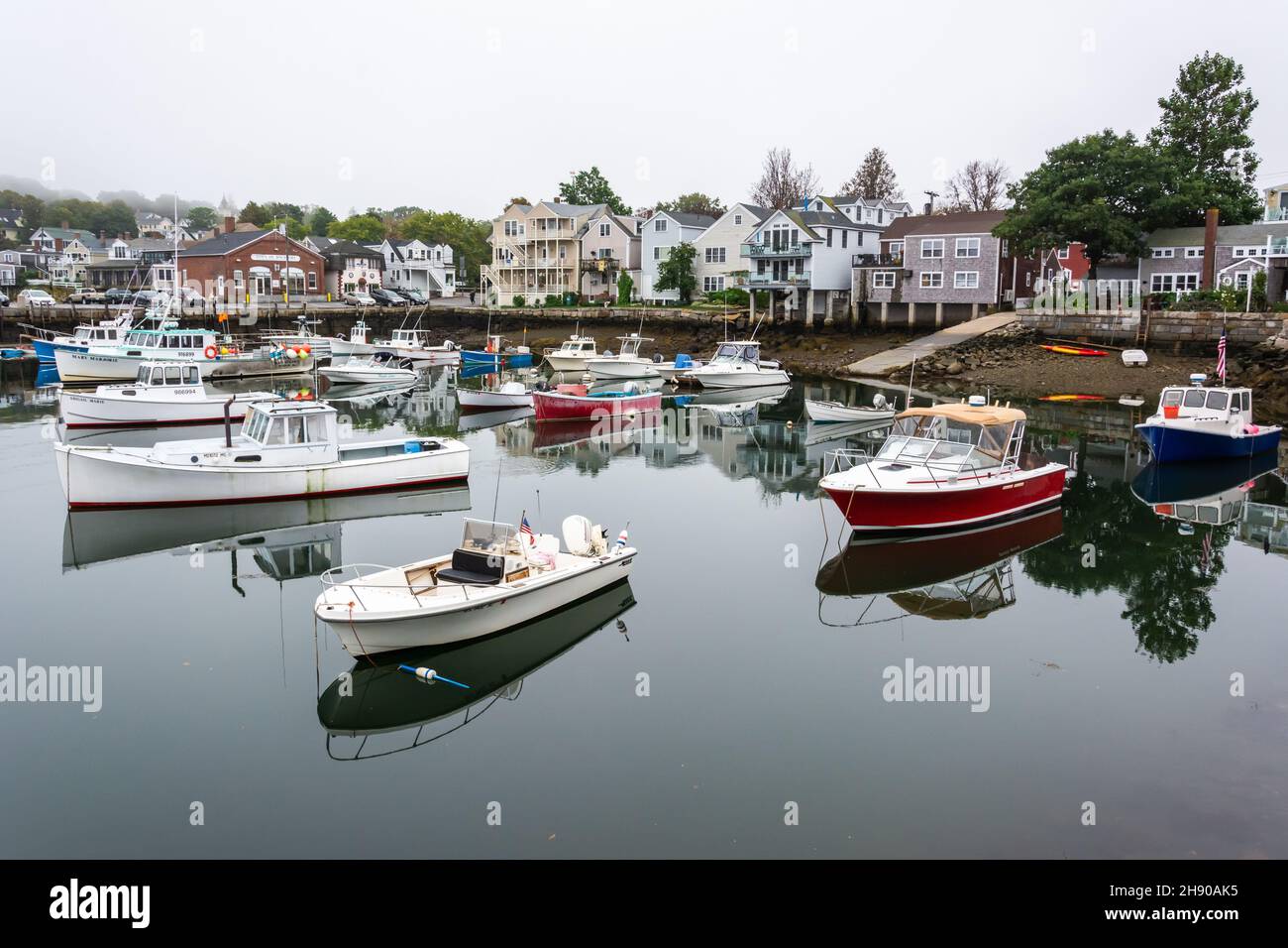 Rockport, Massachusetts, United States of America – September 19, 2016. Harbour of Rockport, MA. View with boats and historic buildings on a foggy day Stock Photo