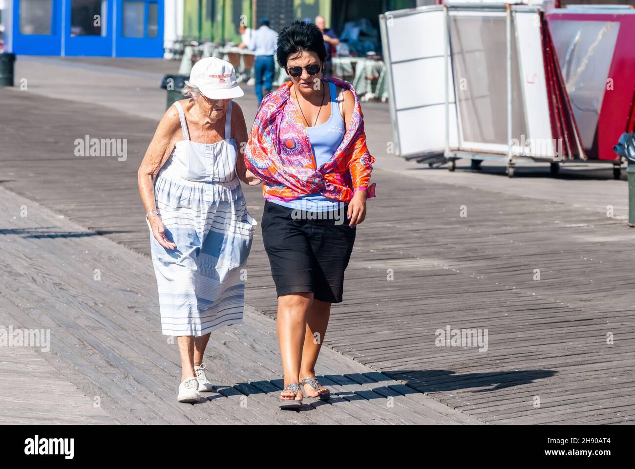 New York City, New York, United States of America – September 22, 2016.  Two ladies of former Soviet origin, walking on Riegelmann Boardwalk along the Stock Photo