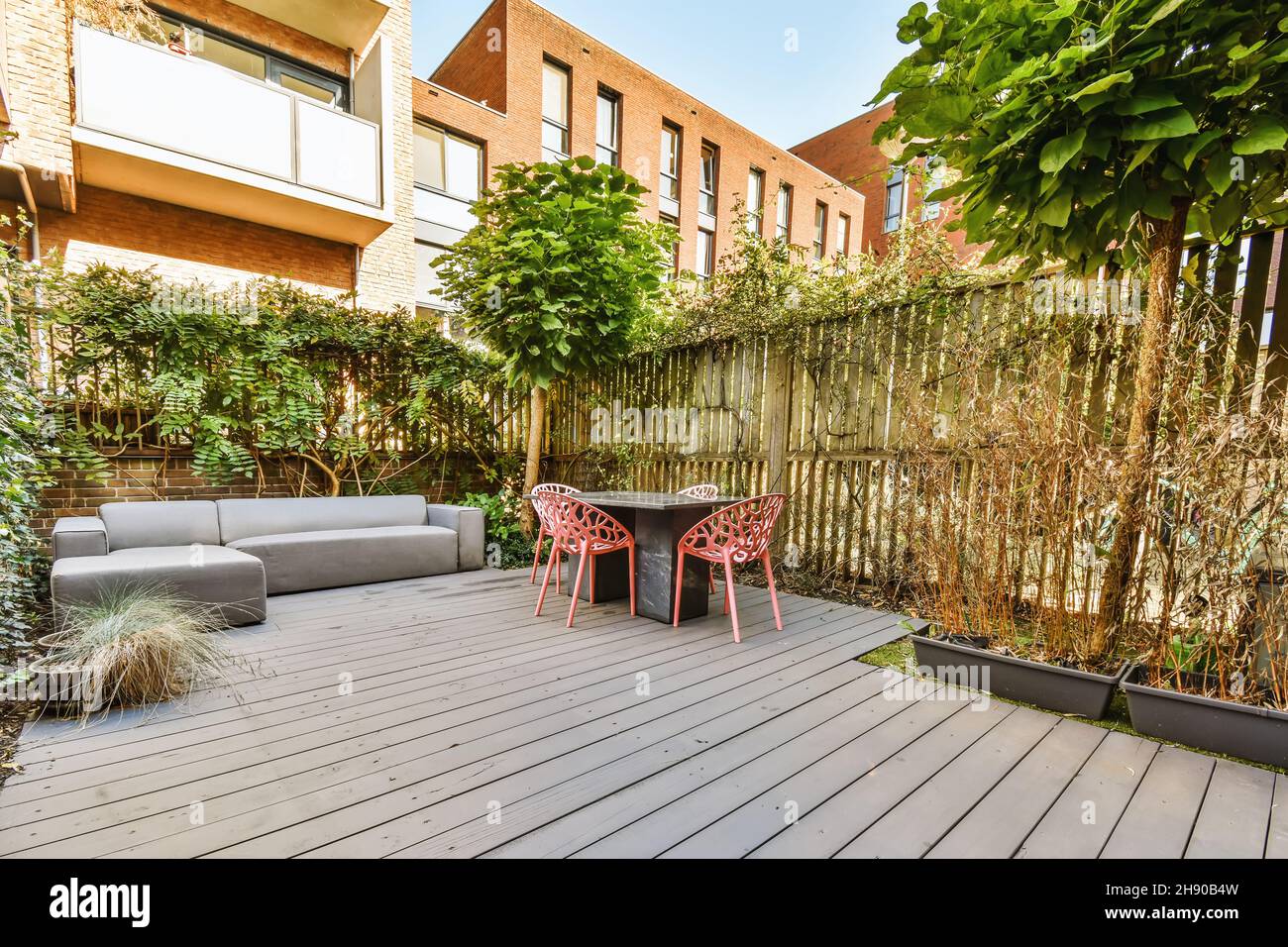 Cozy courtyard of the house with table and chairs Stock Photo - Alamy