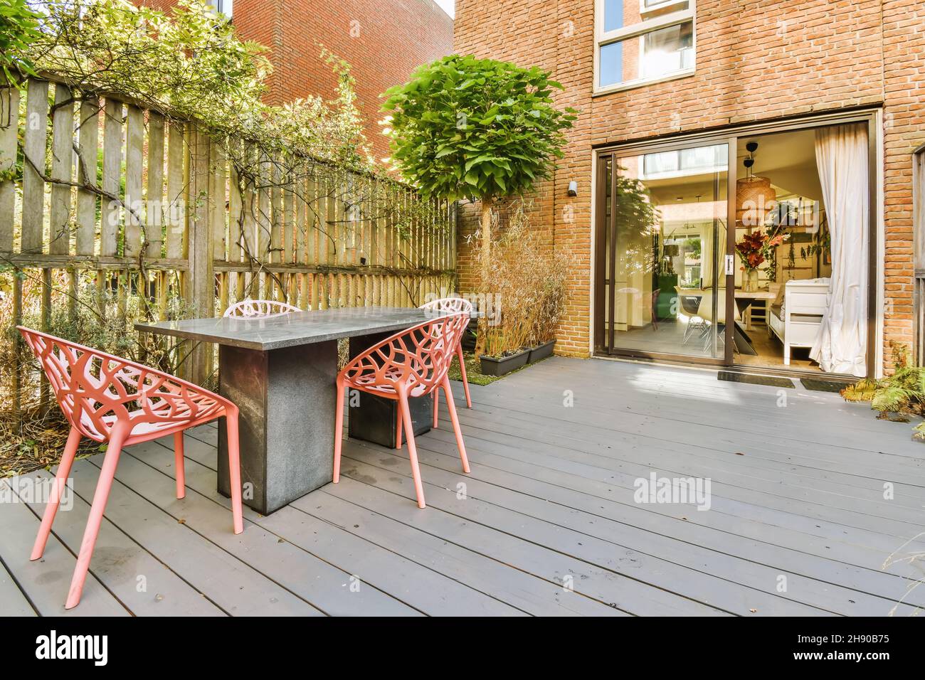 Cozy courtyard of the house with table and chairs Stock Photo - Alamy