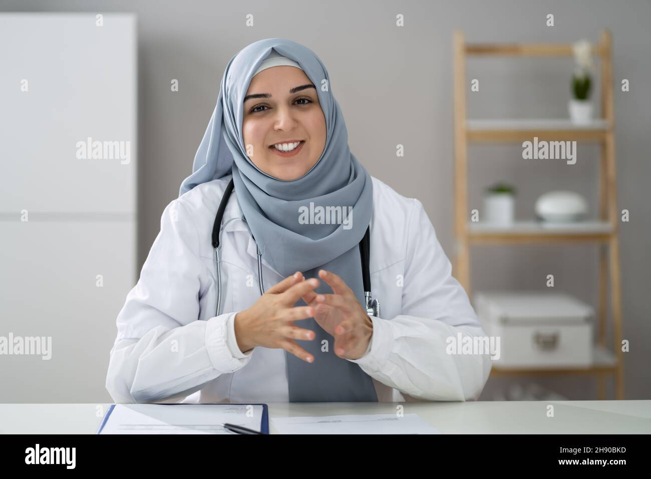Muslim Woman Physician Doctor Video Conference Call Stock Photo
