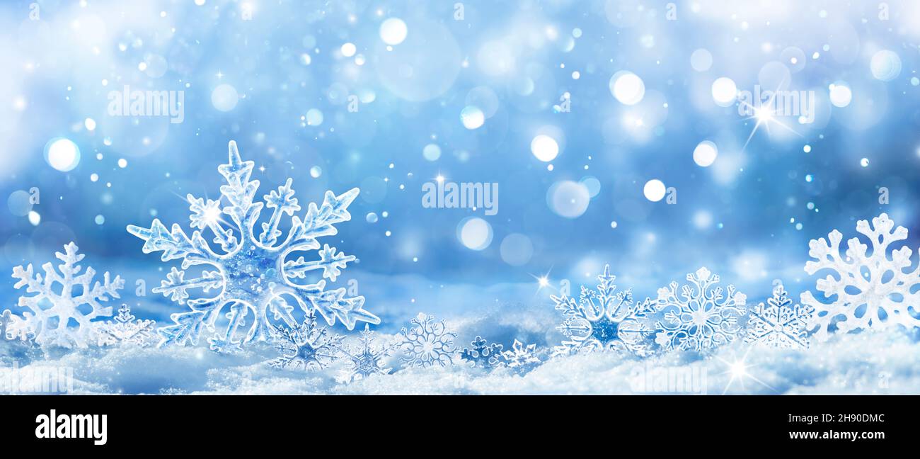 Snowflakes On Snow - Christmas And Winter Background - Natural Snowdrift Close Up With Abstract Light Stock Photo