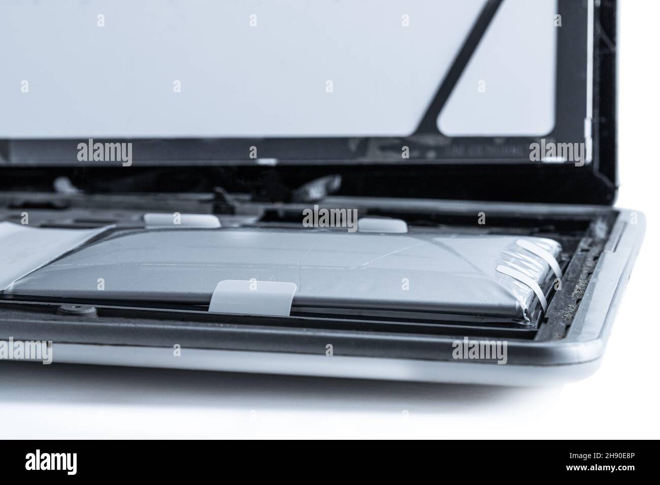 Tablet destroyed by exploded lithium battery isolated on white Stock