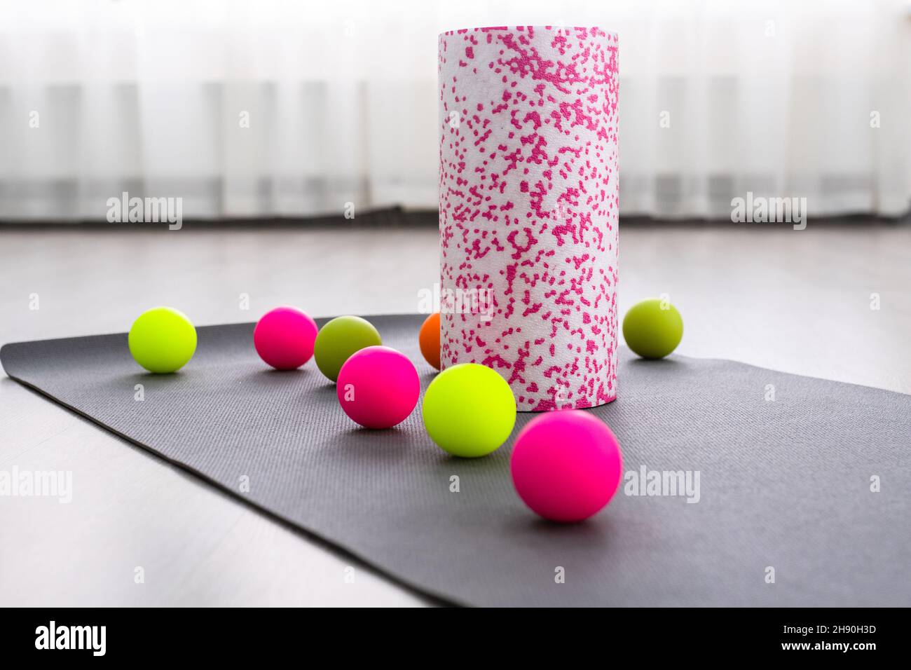 Colored Myofascial release massage balls, roll and other body roll recover on gray mat Stock
