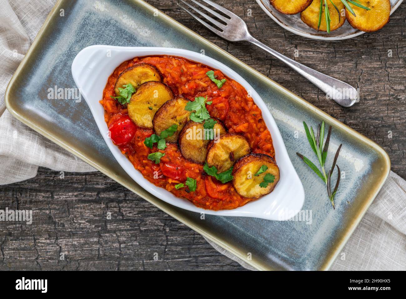 Jollof rice with deep fried plantain spicy vegetarian African rice