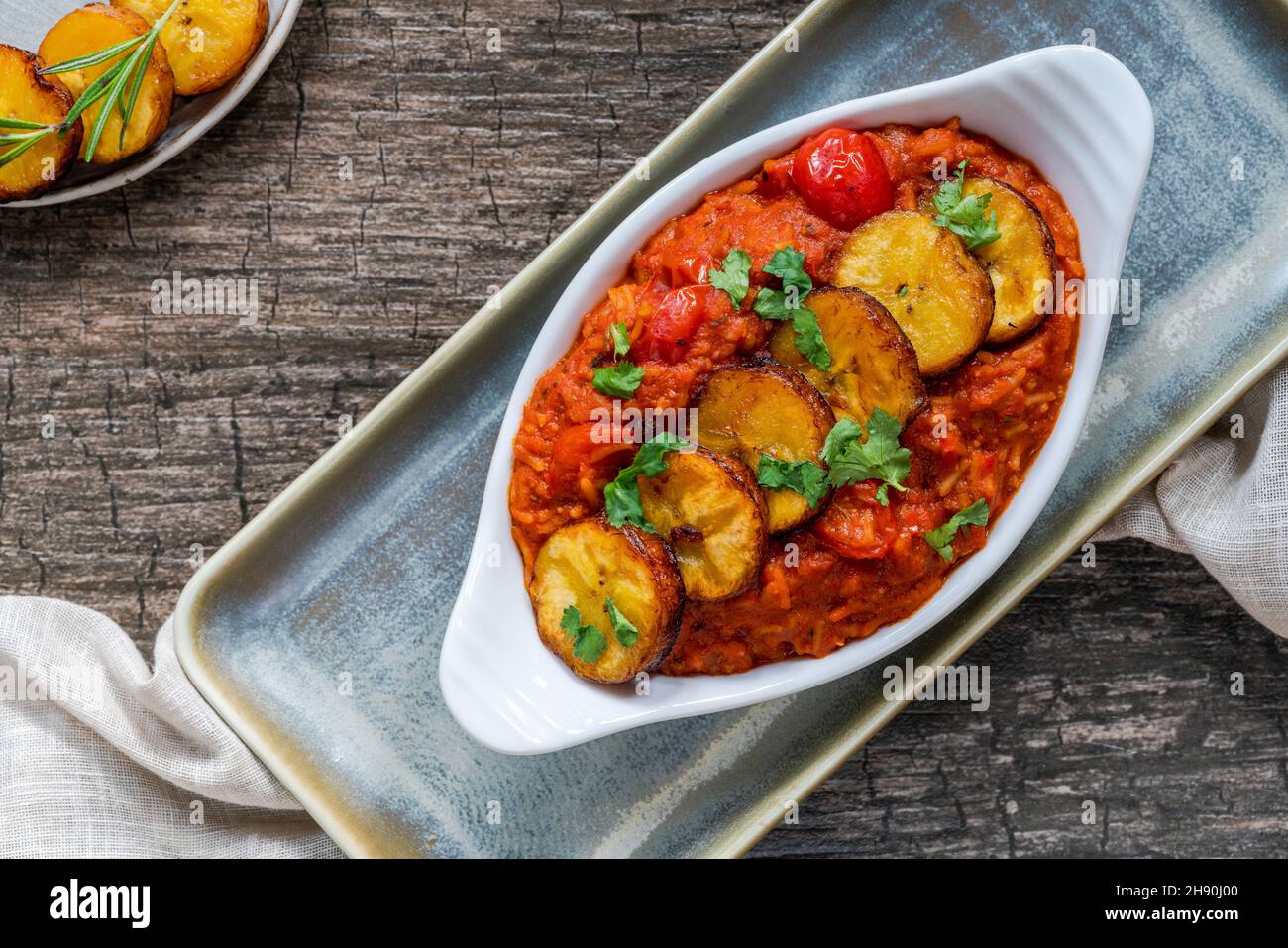 Jollof rice with deep fried plantain spicy vegetarian African rice