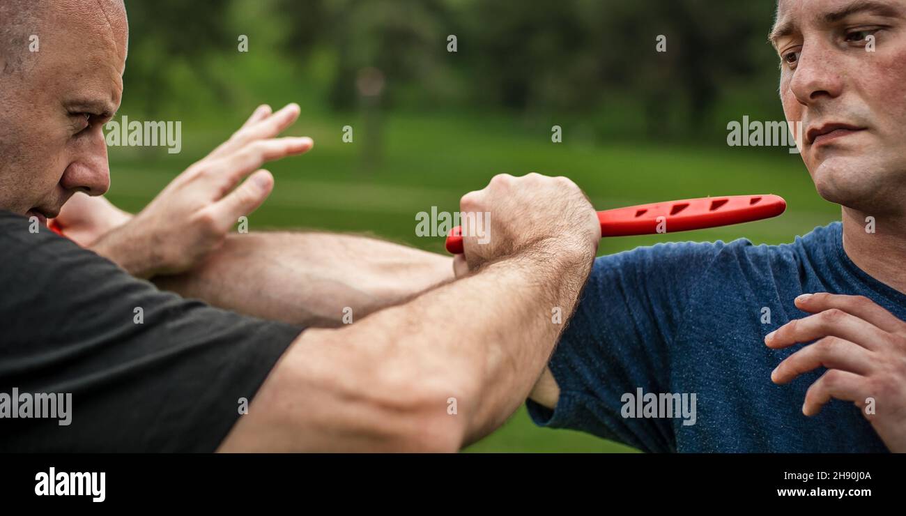 Knife vs knife fight. Kapap instructor demonstrates martial arts self