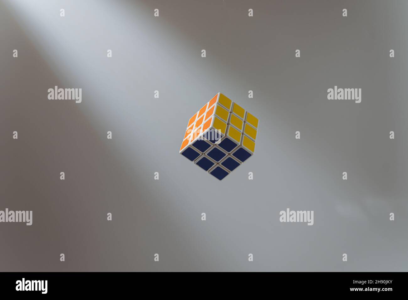 colorful cube flying to light on white background, selective focus, material concept Stock Photo