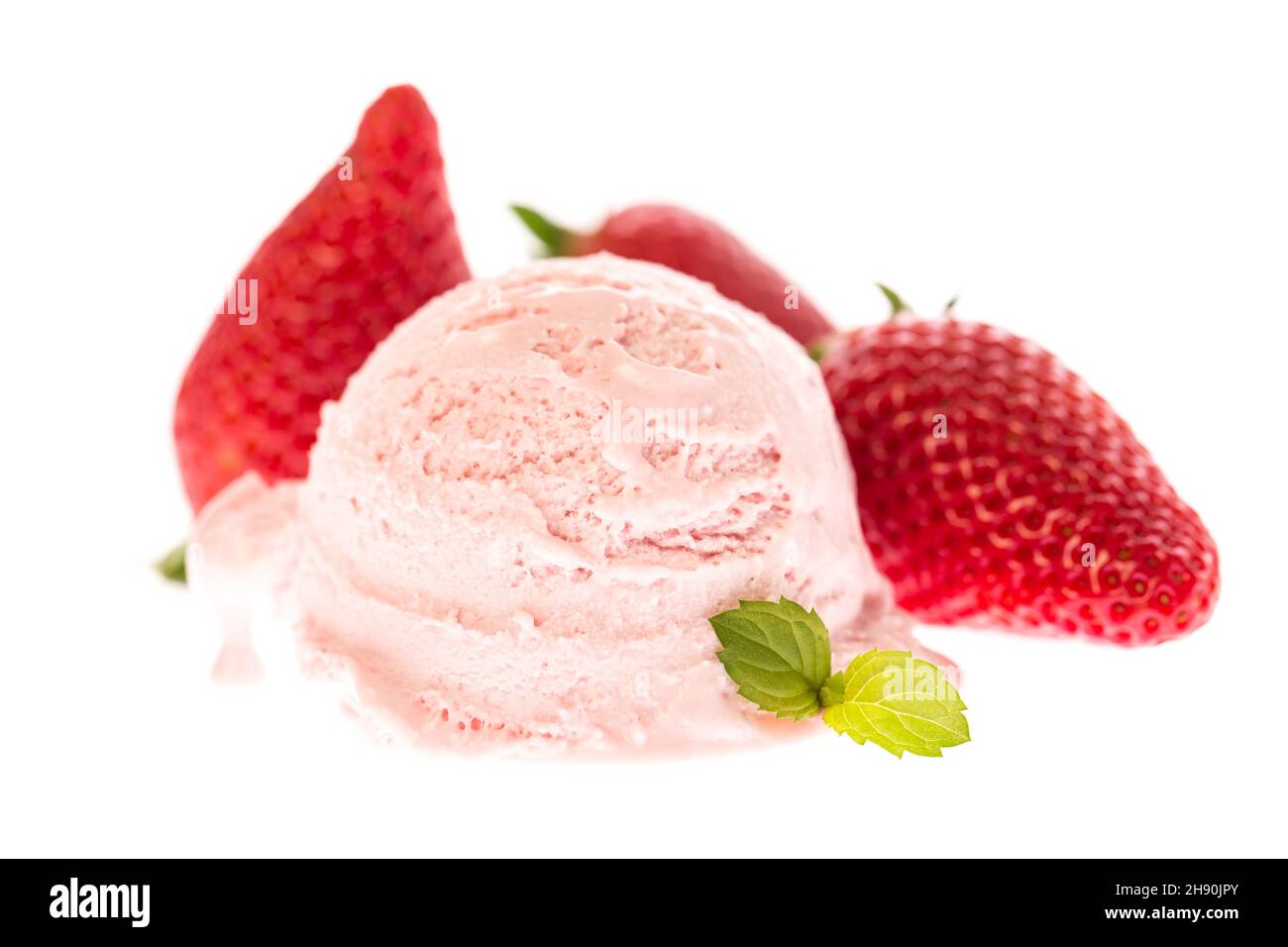 A scoop of strawberry ice cream with mint and strawberries Stock Photo