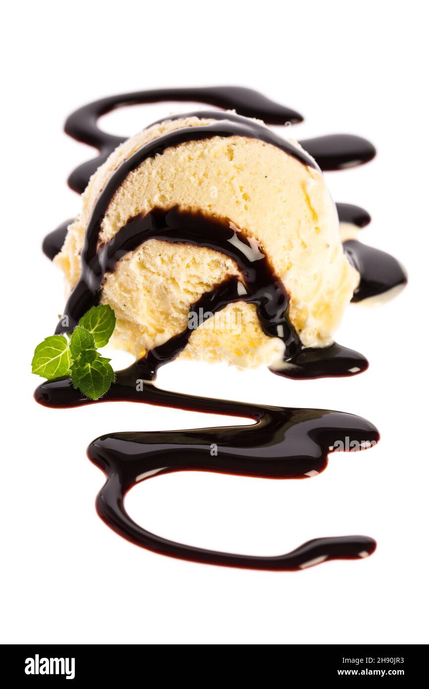 A scoop of vanilla ice cream topped with chocolate sauce Stock Photo