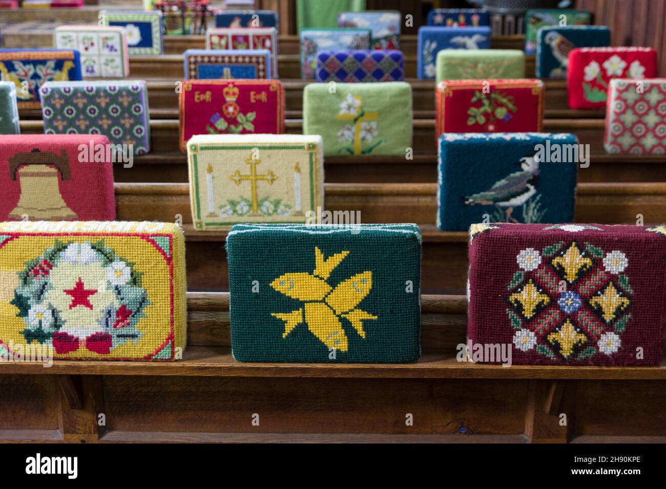 Embroidered kneelers, prayer cushions or hassocks in the chapel of St Andrews Hospital, Northampton, UK Stock Photo