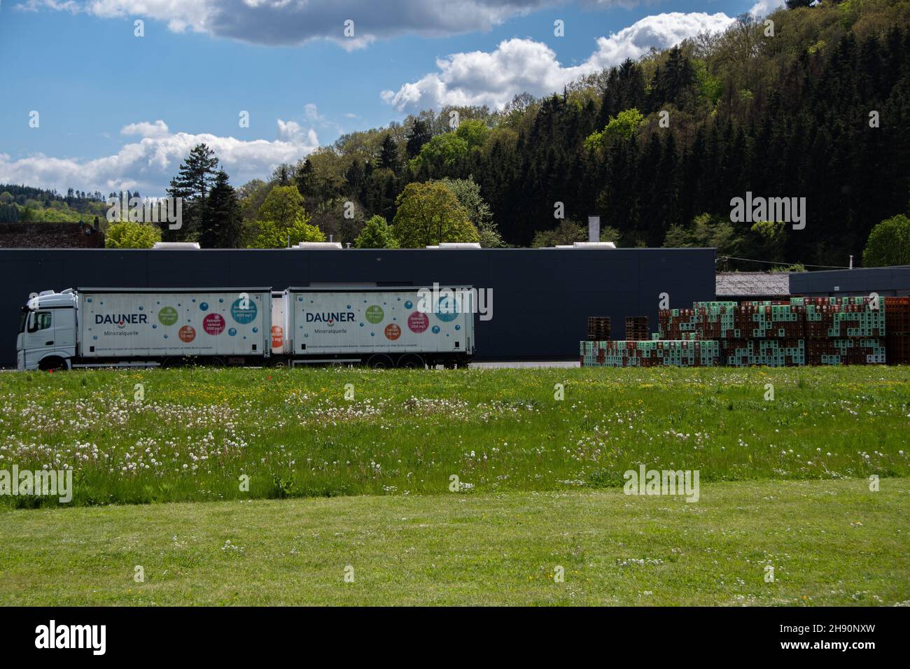 Daun, Germany  29 May 2021,   The location of 'Dauner' mineral water with a truck and many water boxes in Daun Stock Photo