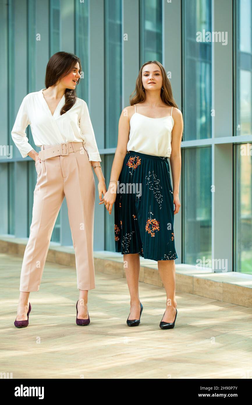 Full length portrait of two young business women Stock Photo - Alamy