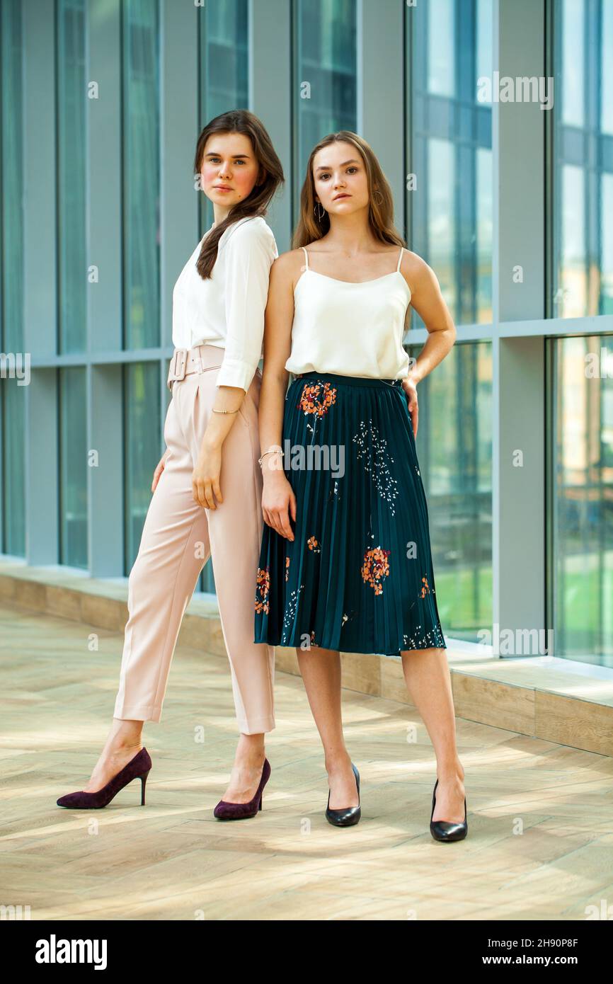 Full length portrait of two young business women Stock Photo - Alamy