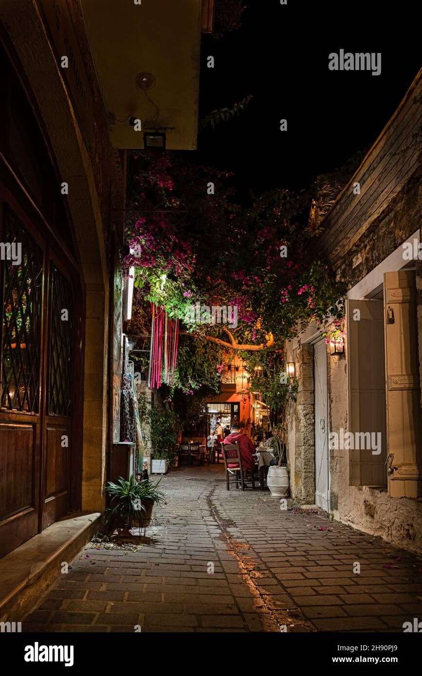 sitting under the streetlights in a narrow alley in the old town of Chania, Crete, Greece, October 16, 2021 Stock Photo