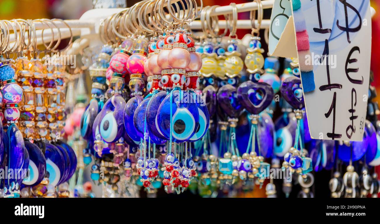 Nazar symbol keychain souvenirs, Camel Beach near Bodrum, Turkey Stock Photo