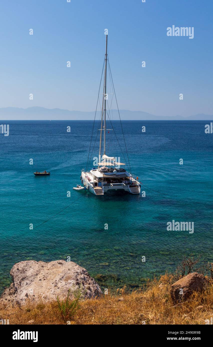rear view of catamaran with mast moored on clear blue sea Stock Photo