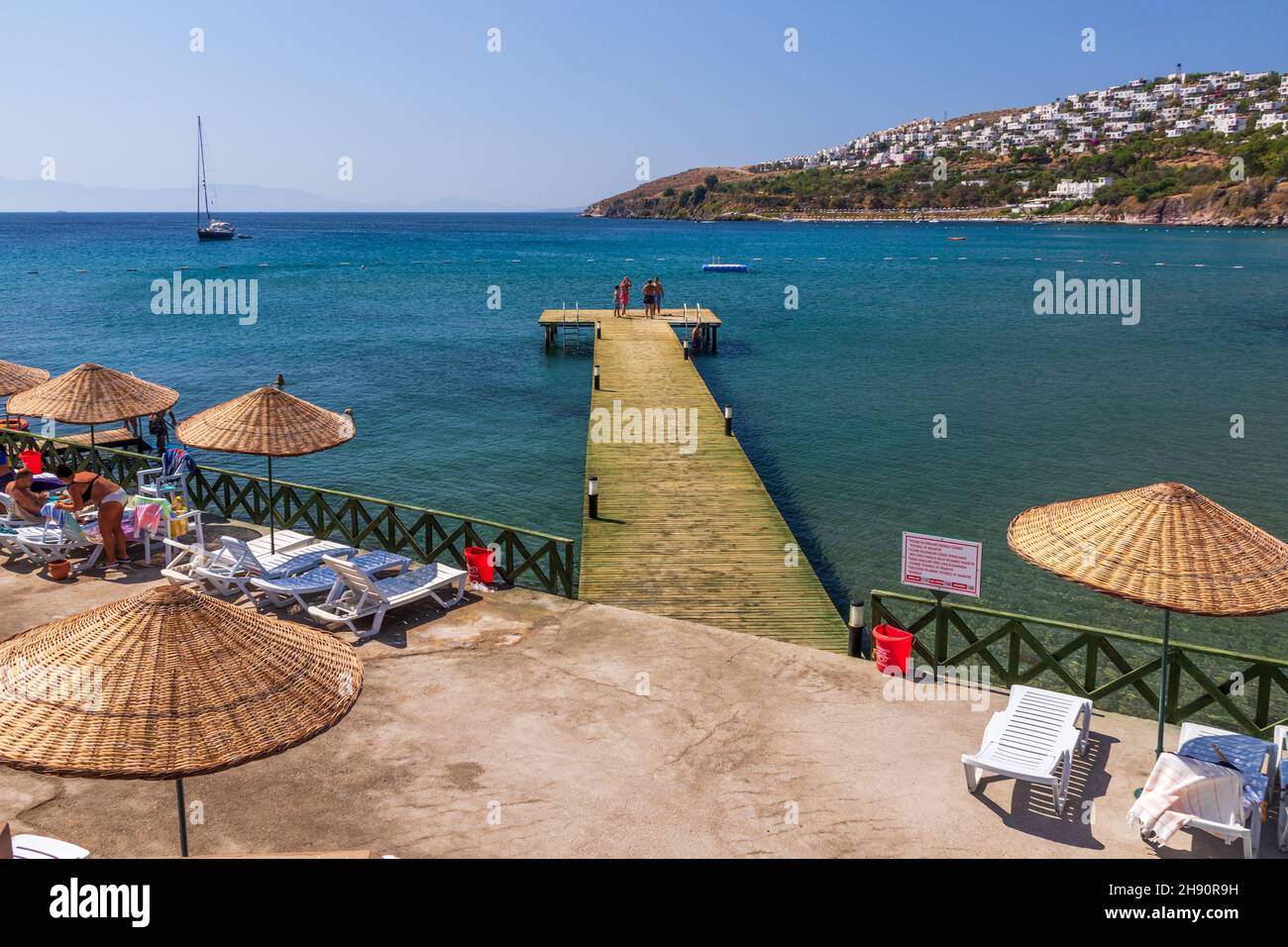 looking out overAegean sea near Bodrum,  with swimmers on jetty Stock Photo