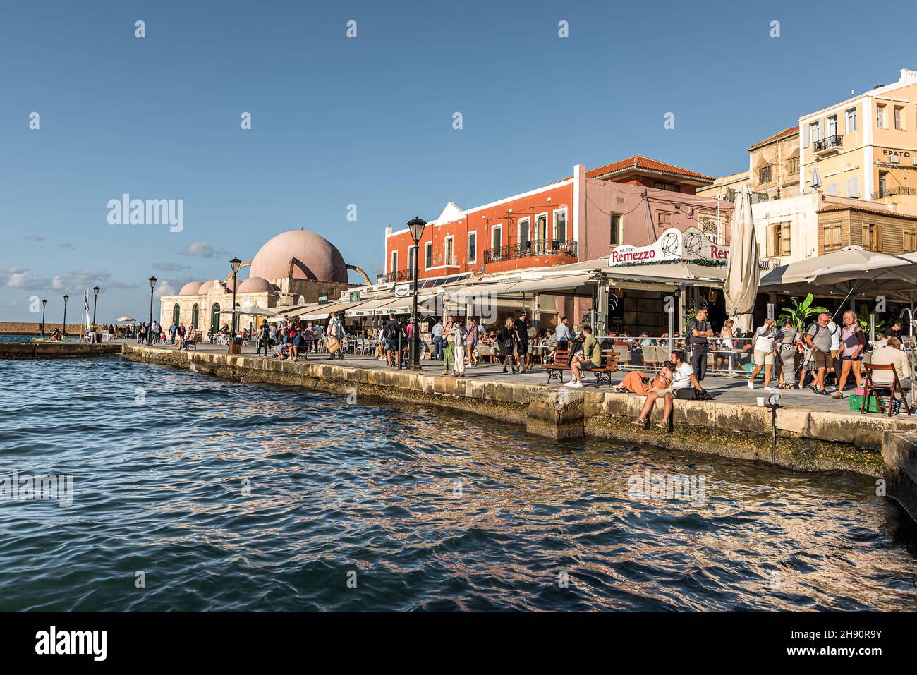 People on the promenade in the venetian harbour of Chania, Crete, Greece, October 16, 2021 Stock Photo
