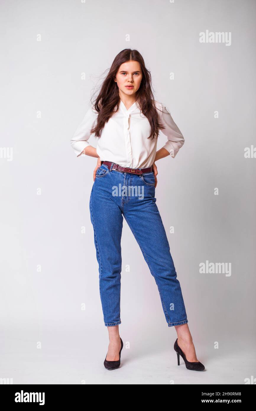 Portrait full body of young beautiful brunette girl in blue jeans ...