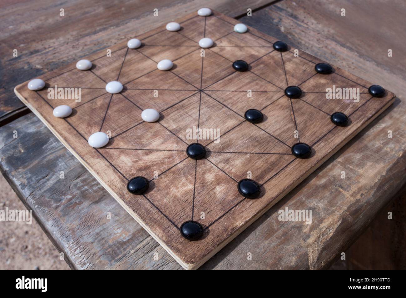 Alquerque, also known as Qirkat. Strategy board game originated in the Middle East. Stock Photo