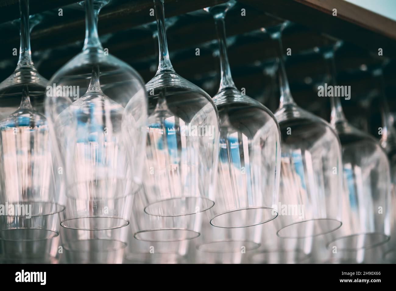 Glasses hanging over bar rack. Empty glasses for wine above a bar rack