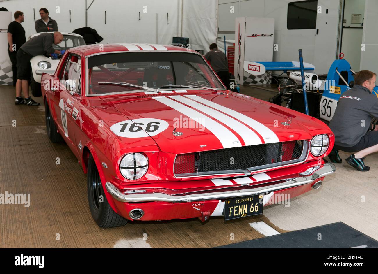 View of the JDR Racing Teams pit Garage, with Robb Fenns, Red,  1965, Ford Mustang, at the front, at the 2021 Silverstone Classic Stock Photo