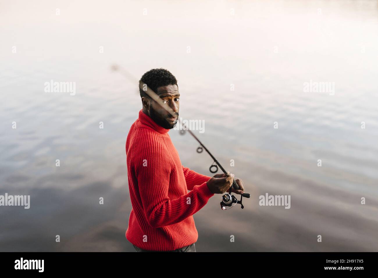 Man holding fishing rod hi-res stock photography and images - Alamy