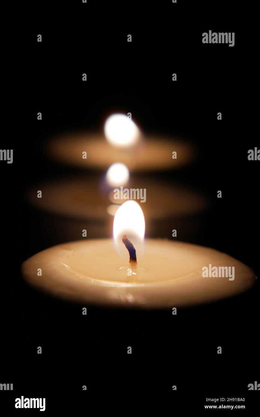 color candles slowly burning down in dark Stock Photo Alamy