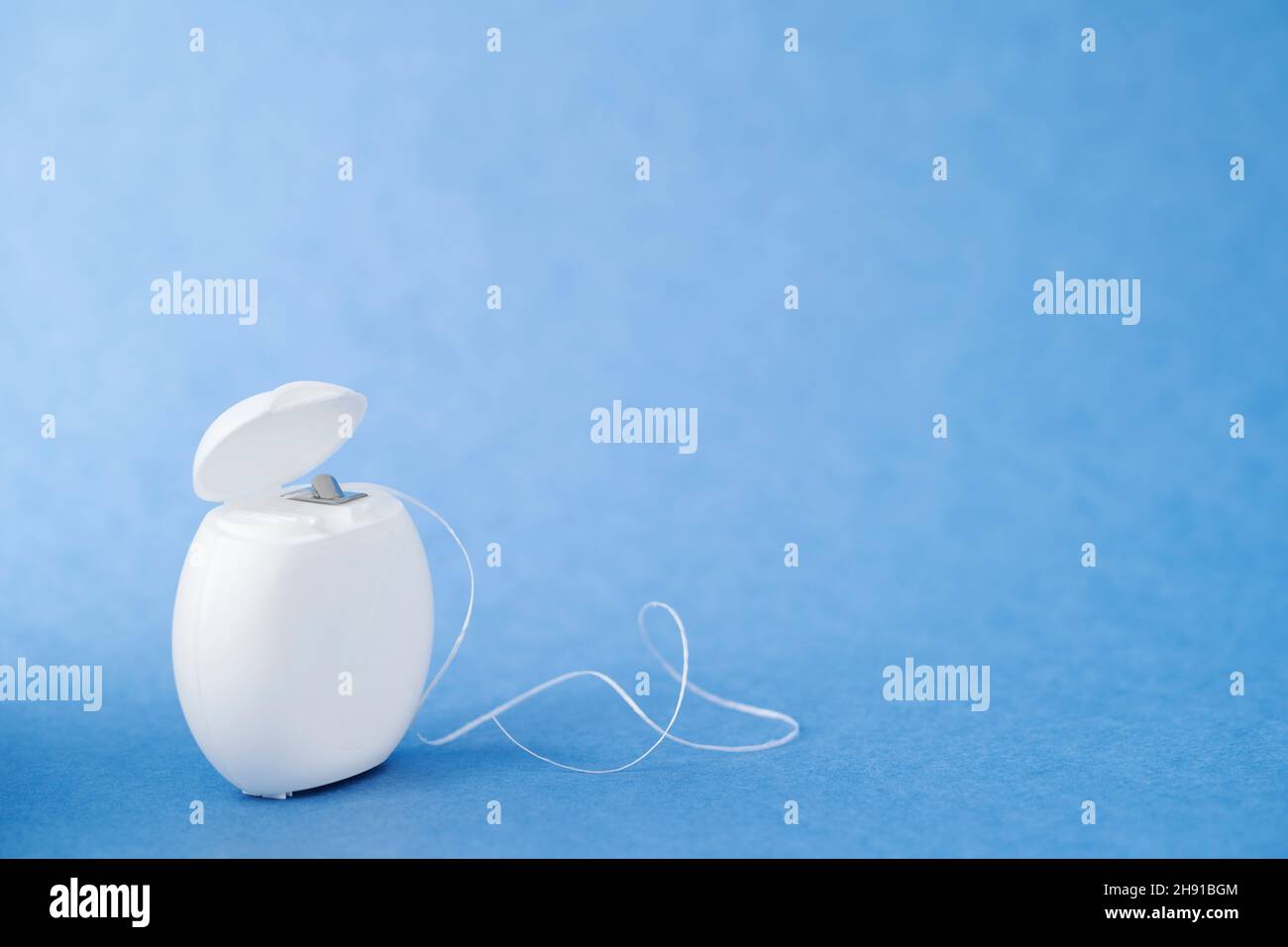 Container with dental floss. Open dental floss container Stock Photo