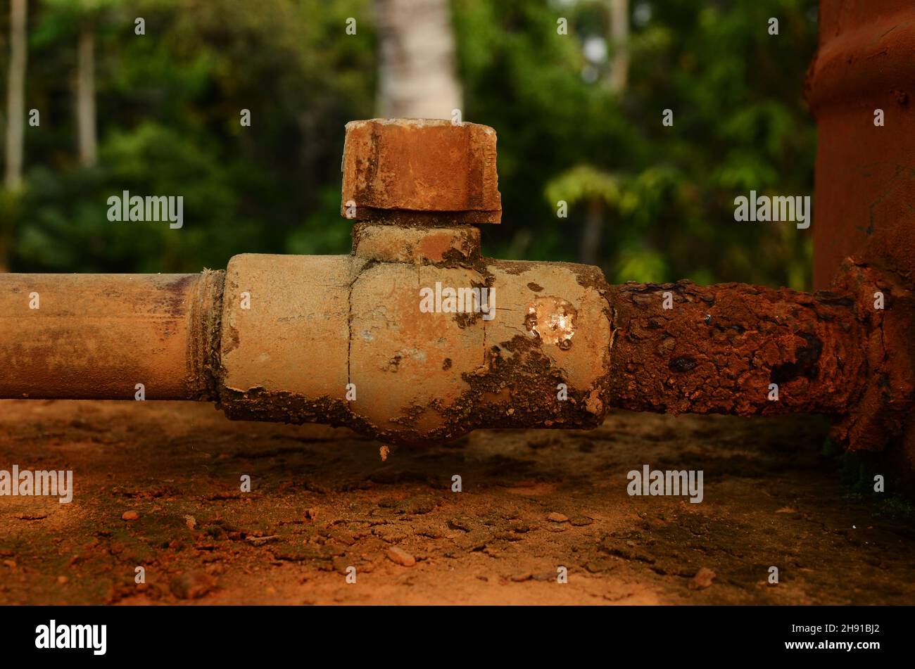 Another pipe is added to the corroded water pipe Stock Photo