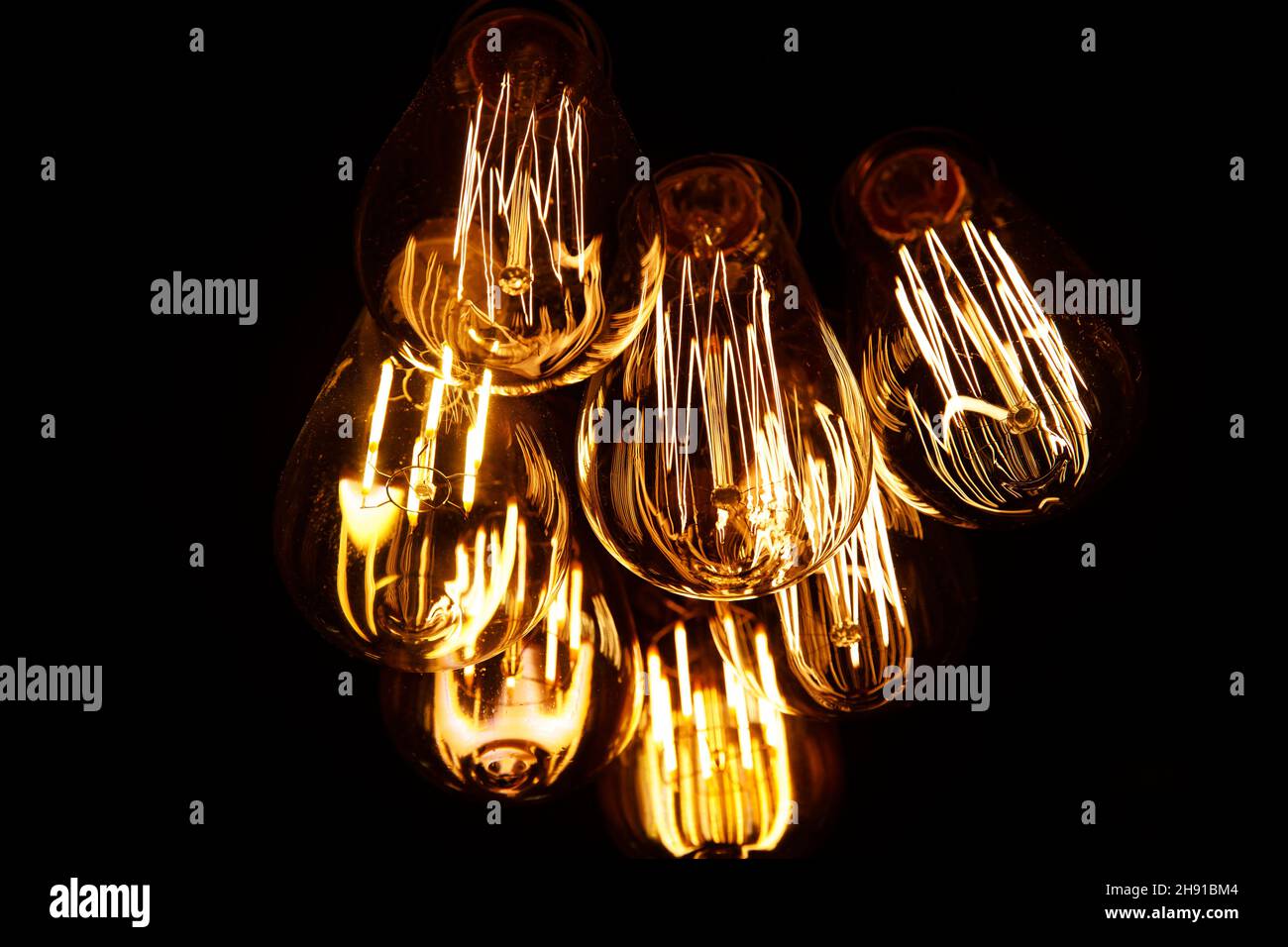 Warm light bulb, close up of filaments inside Stock Photo Alamy