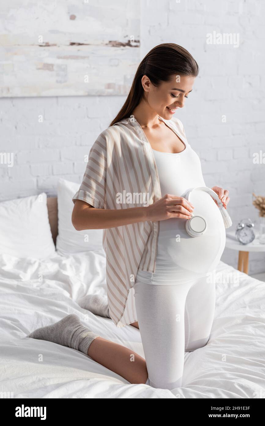 Belly pregnant woman with headphones Stock Photo by ©svyatoslavlipik  34774629