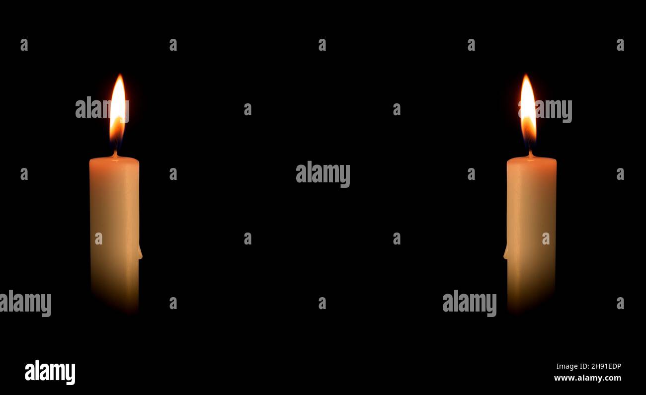Two burning candles on a black background. Religious rituals Stock Photo