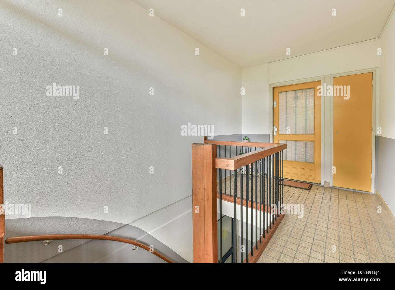 Corridor with wooden staircase and glass railings Stock Photo - Alamy