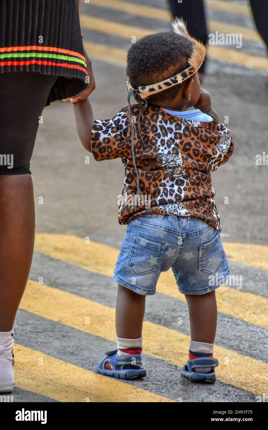 A mother holding hands with her son toddler in zulu outfit in Pretoria south africa symbolizing strength, future and hope of a new generation of leade Stock Photo