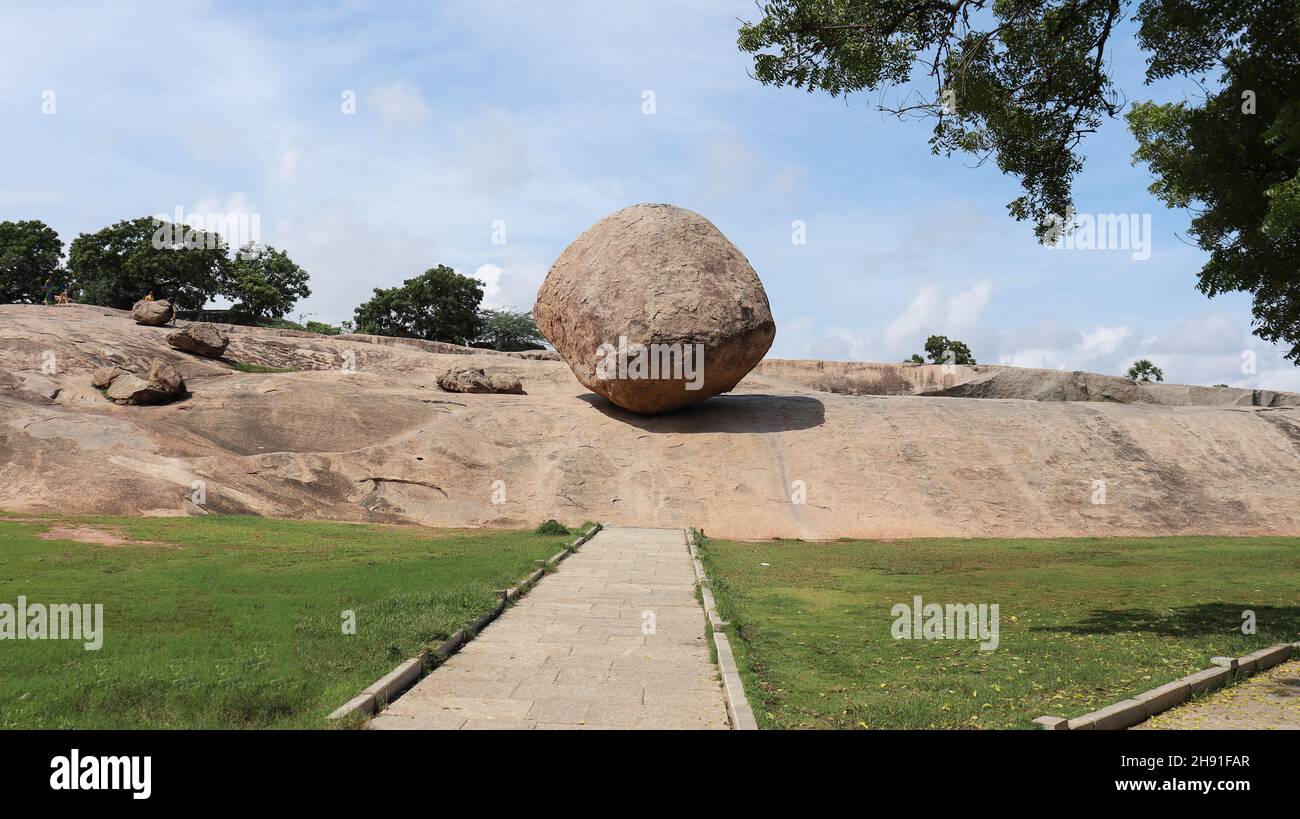 Krishna Butter Ball Large rock and blue sky. A balance rock. Located in the natural background. Stock Photo