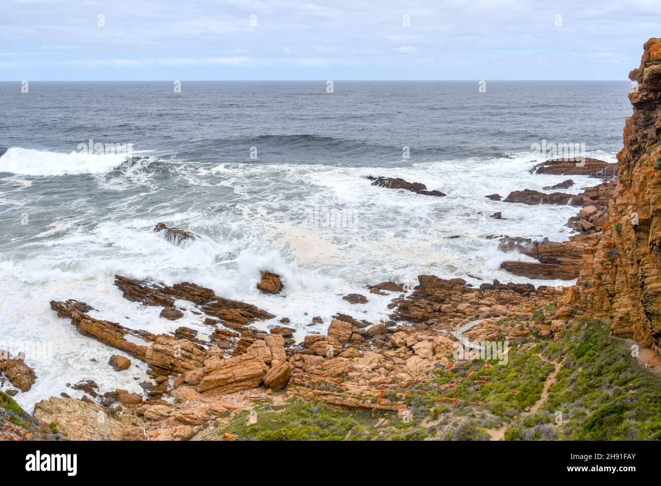The Indian Ocean seen from the Point of Human Origins near Mosselbay on the Garden Route in South Africa with rock formations and waves in an area kno Stock Photo