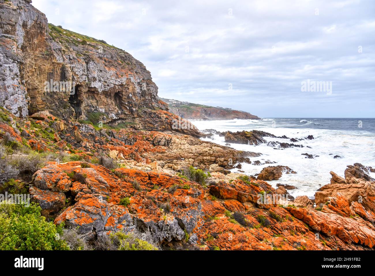 The Indian Ocean seen from the Point of Human Origins near Mosselbay on the Garden Route in South Africa with rock formations and waves in an area kno Stock Photo