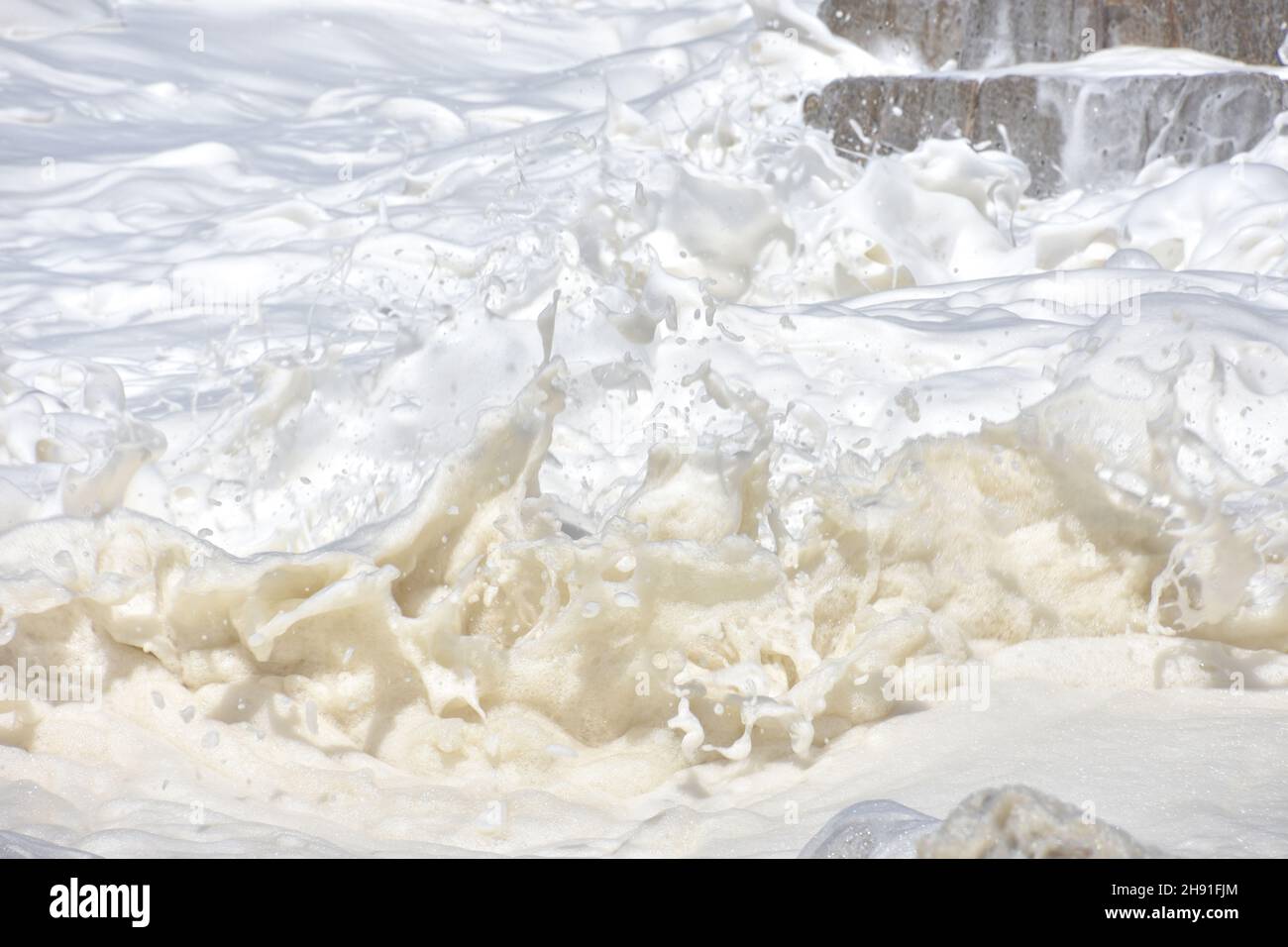 Artisitic and abstract background of foam created by waves in the Indian Ocean seen from the Oyster Catcher Trail near Mosselbay on the Garden Route i Stock Photo