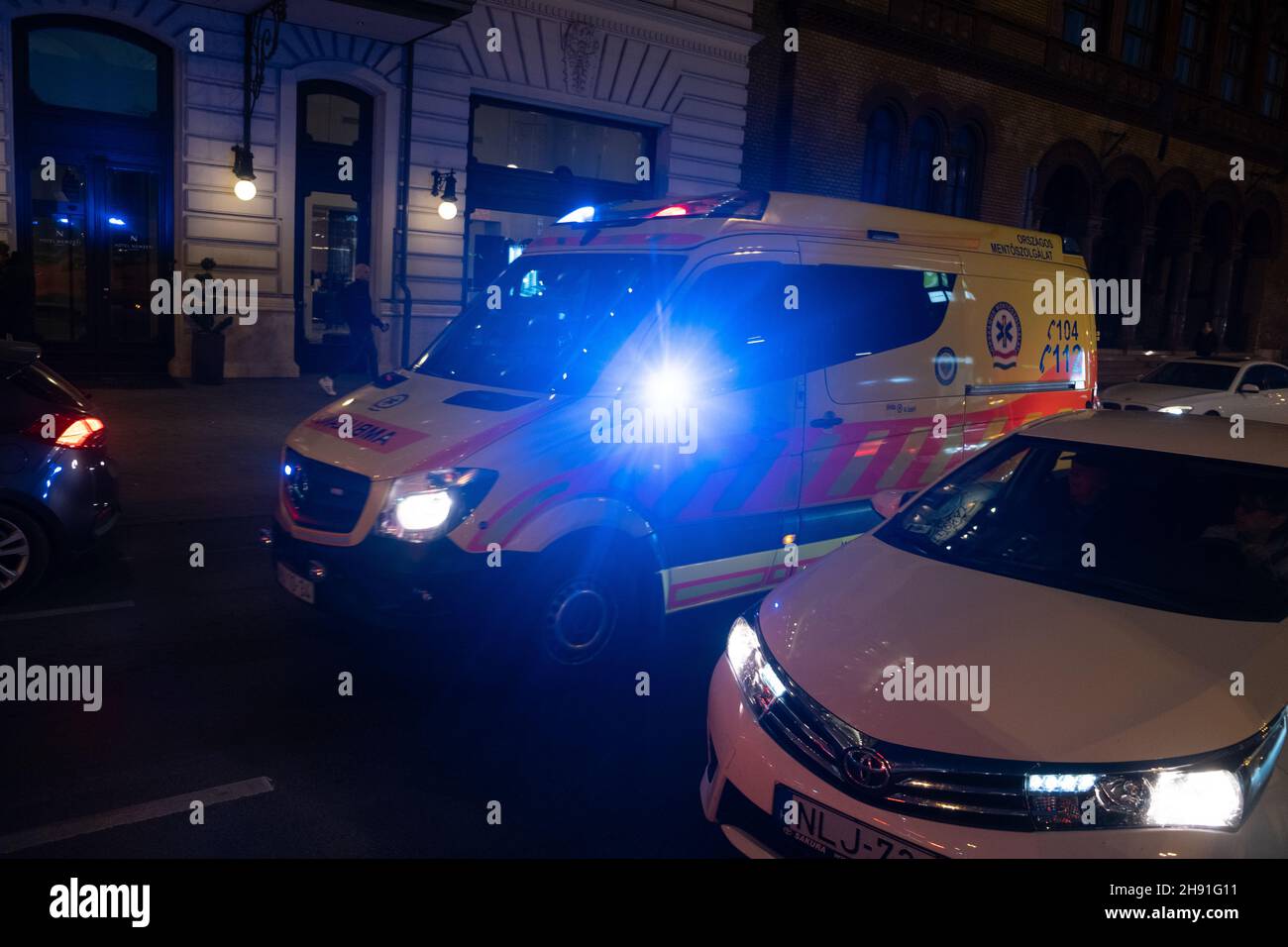 Budapest, Hungary - 1 November 2021: Hungarian ambulance van car rides through the city at night, Illustrative Editorial. Stock Photo