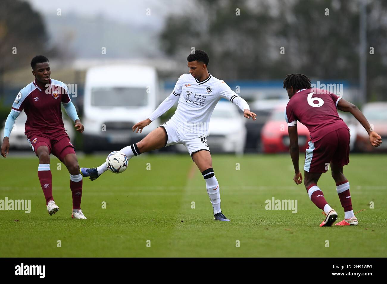 Swansea, UK. 03rd Dec, 2021. Morgan Whittaker #10 of Swansea City U23's under pressure from Aji Alese #6 of West Ham U23's and Levi Laing #5 of West Ham U23's in Swansea, United Kingdom on 12/3/2021. (Photo by Ashley Crowden/News Images/Sipa USA) Credit: Sipa USA/Alamy Live News Stock Photo